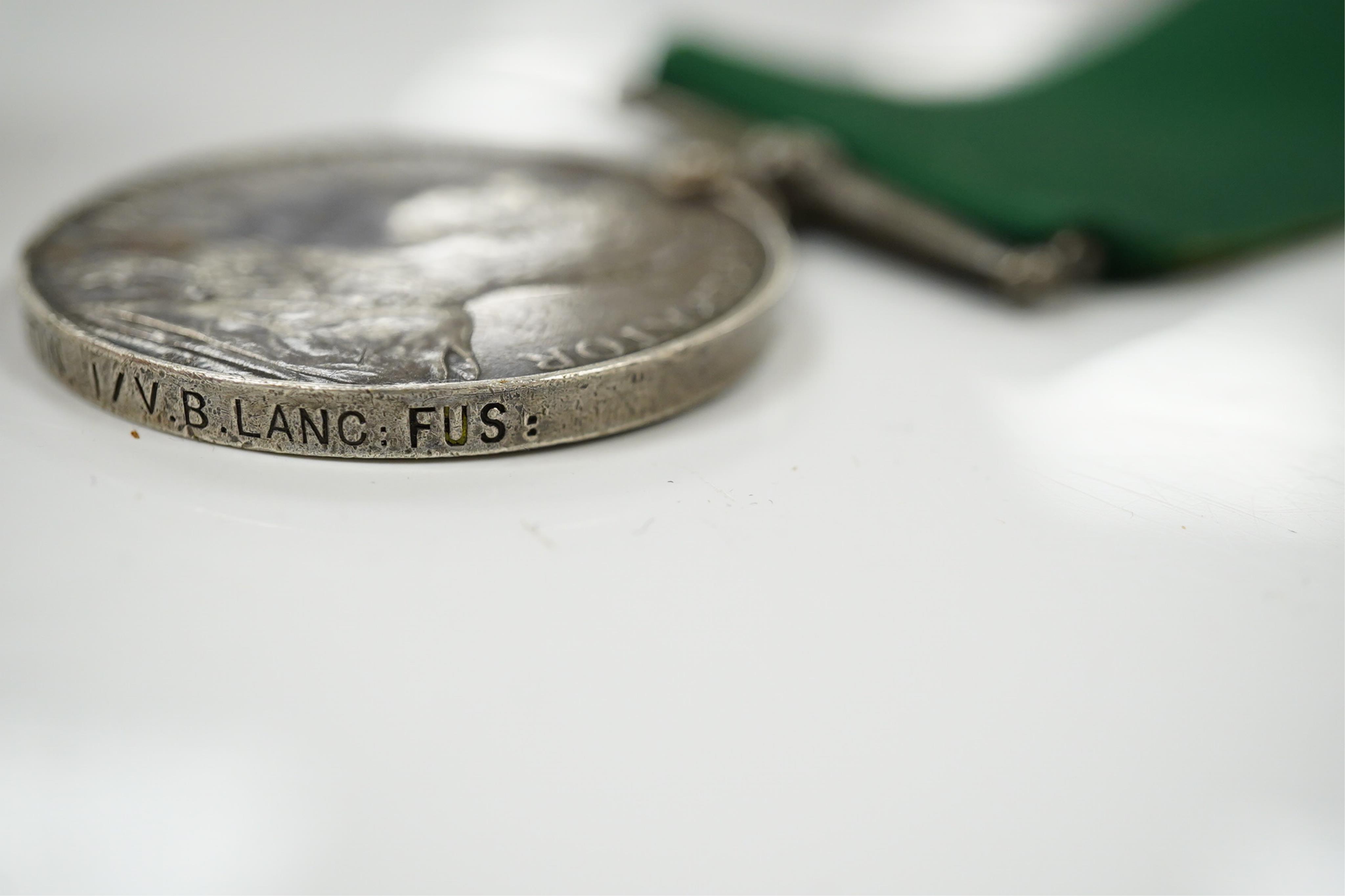 Four assorted service medals; Volunteer Officer's Decoration, hallmarked for 1892; EdVII Volunteer Long Service Medal to 3648 Pte W.Austin I/V B:Lanc:Fus; GV Imperial Service Medal to Frederick Allan Heselwood & Gv Regul